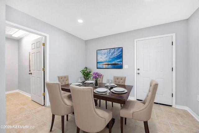 dining area featuring baseboards and light tile patterned floors