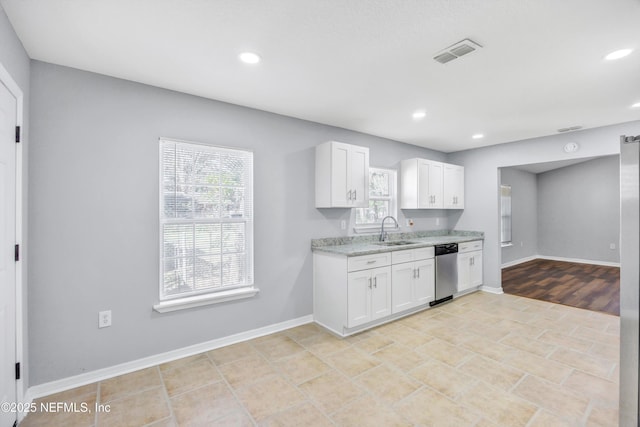 kitchen featuring recessed lighting, a sink, visible vents, white cabinets, and dishwasher