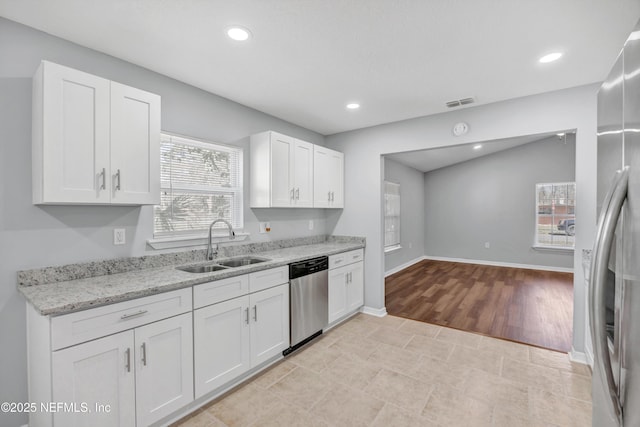 kitchen with recessed lighting, stainless steel appliances, a sink, visible vents, and white cabinets