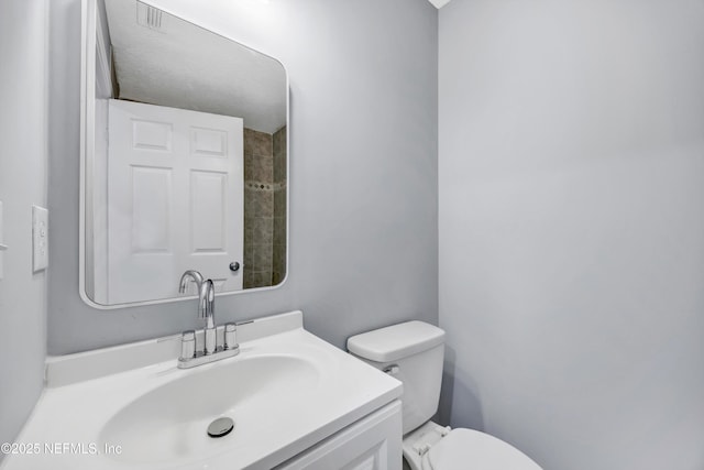 bathroom with toilet and vanity