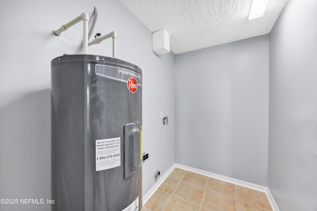 washroom featuring tile patterned floors, baseboards, a textured ceiling, and electric water heater