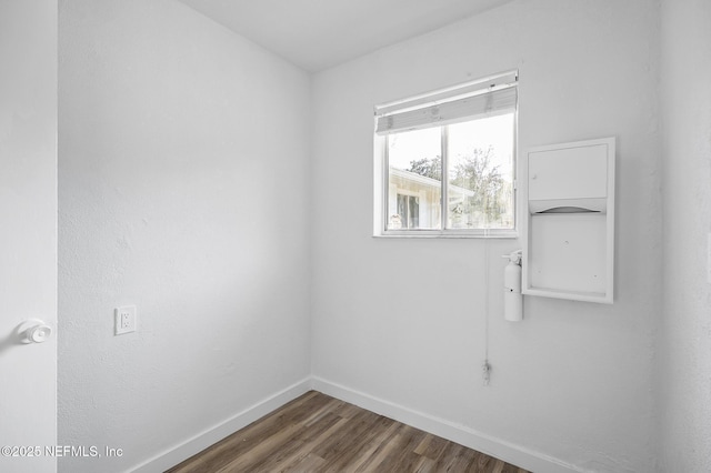 empty room with wood finished floors and baseboards