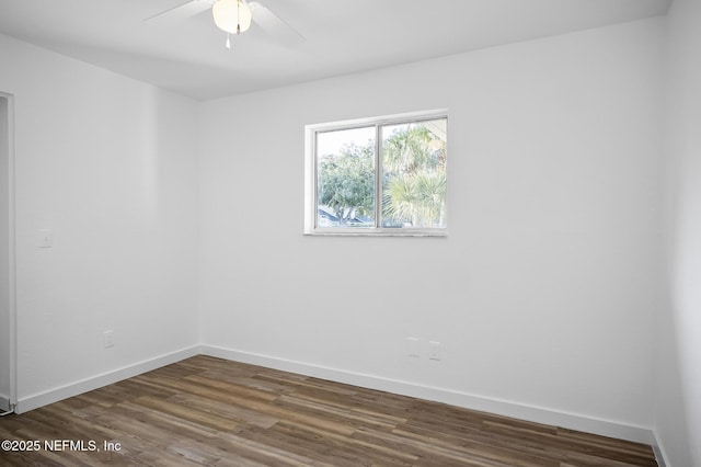 unfurnished room with a ceiling fan, wood finished floors, and baseboards