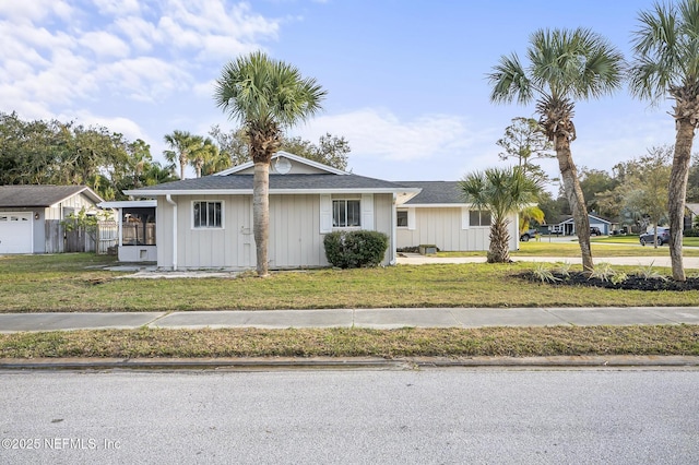 view of front of home with a front yard and fence