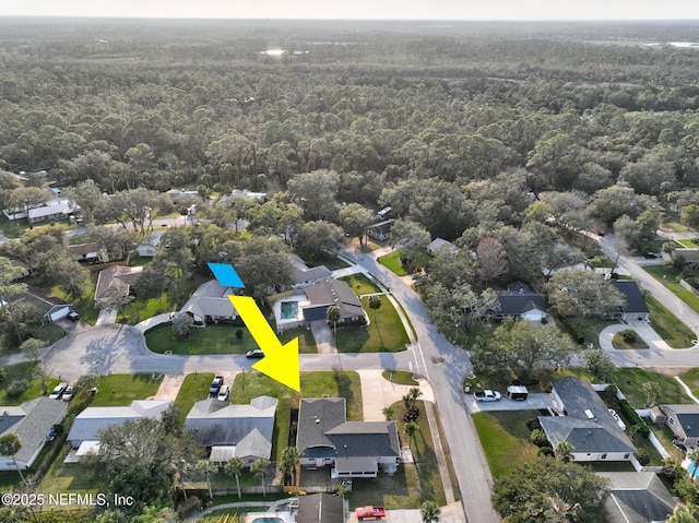 birds eye view of property featuring a residential view and a forest view