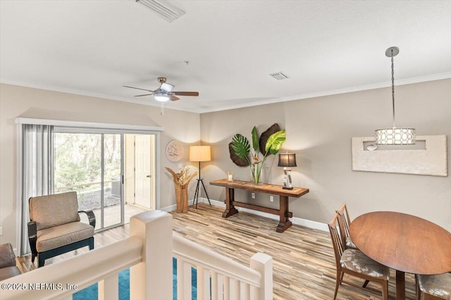 interior space featuring access to outside, visible vents, baseboards, and wood finished floors