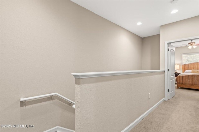 hall featuring an upstairs landing, recessed lighting, carpet flooring, and baseboards