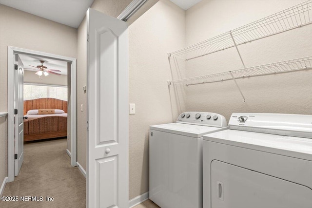 laundry area with light carpet, laundry area, and washing machine and clothes dryer