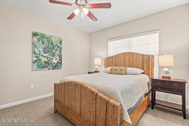 bedroom with light carpet, baseboards, and a ceiling fan