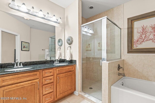 full bathroom with tile patterned flooring, a sink, and a shower stall