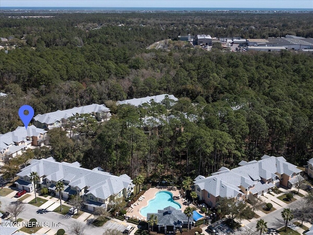 aerial view featuring a wooded view and a residential view