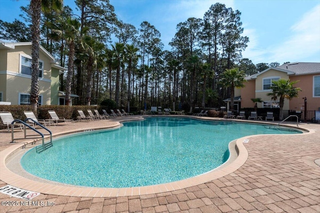 pool featuring a patio area and fence