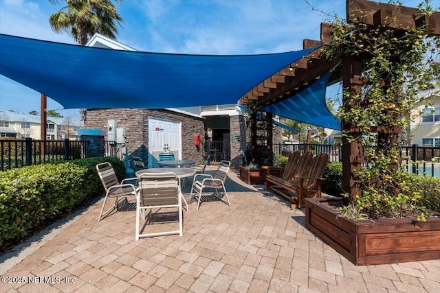 view of patio featuring fence and outdoor dining space