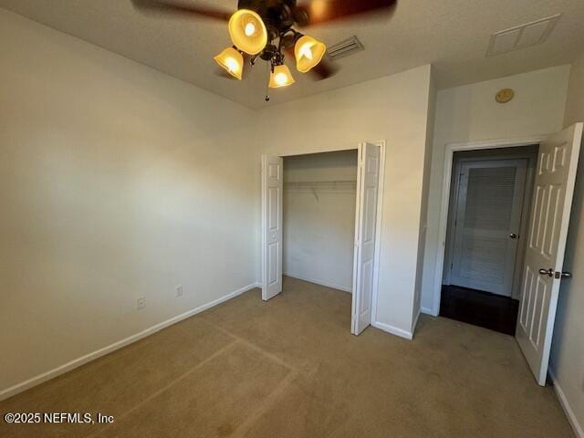 unfurnished bedroom with a ceiling fan, baseboards, visible vents, a closet, and carpet flooring