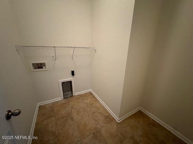 washroom with baseboards, hookup for an electric dryer, washer hookup, and laundry area