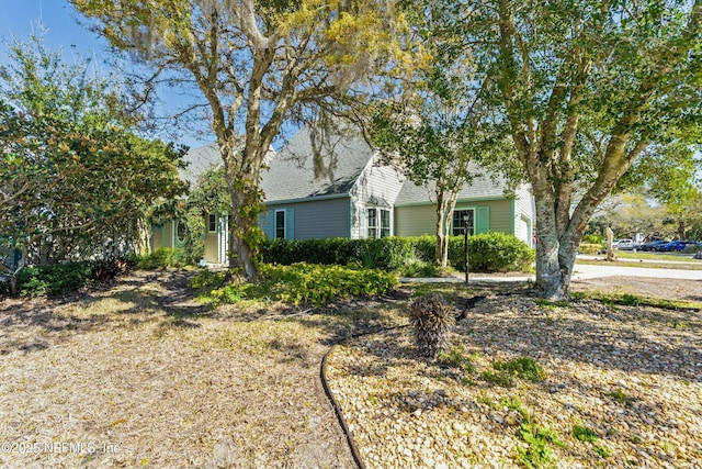 view of front of house with a garage and roof with shingles