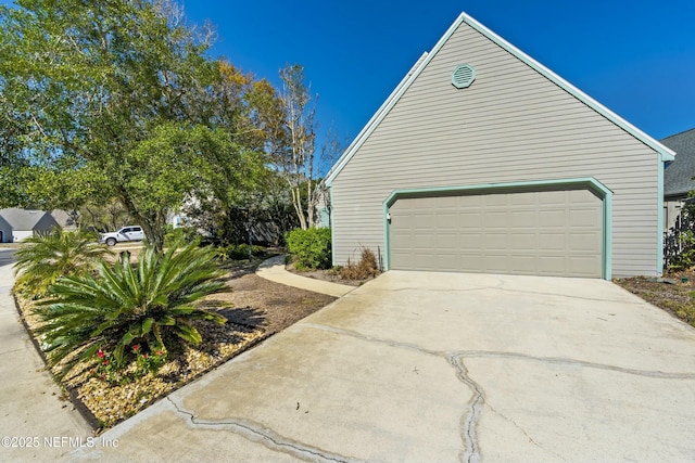 view of home's exterior with a garage and driveway