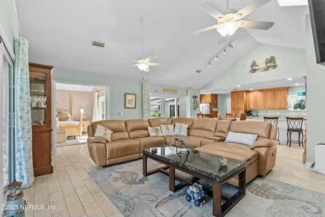 living room with high vaulted ceiling, wood finish floors, visible vents, and ceiling fan