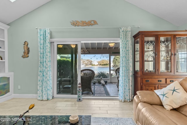 living area featuring vaulted ceiling and wood finish floors