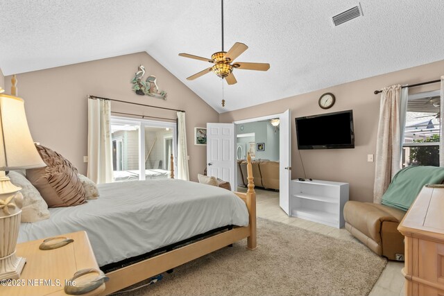 bedroom with lofted ceiling, access to exterior, visible vents, and a textured ceiling