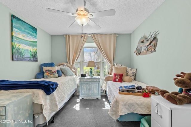 carpeted bedroom featuring a textured ceiling and a ceiling fan