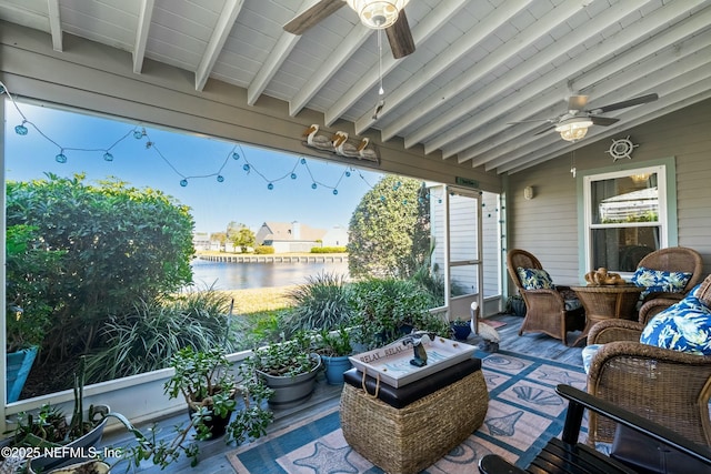 view of patio with a ceiling fan and a water view