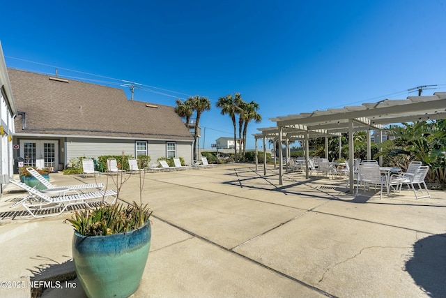 view of home's community with a pergola and a patio