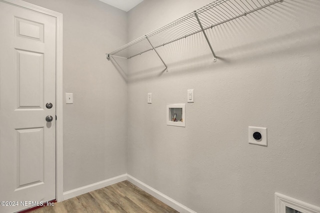 laundry area featuring wood finished floors, baseboards, hookup for an electric dryer, laundry area, and washer hookup