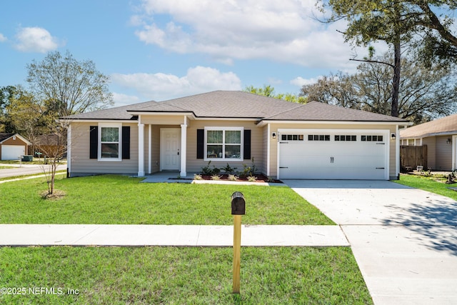 view of front of house with driveway, a front lawn, roof with shingles, and an attached garage