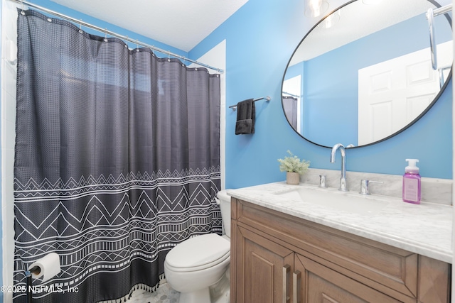 bathroom featuring vanity, a shower with shower curtain, and toilet