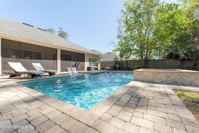 view of pool featuring a fenced in pool, a sunroom, a fenced backyard, and a patio area