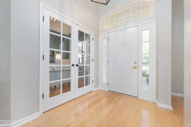 foyer with baseboards and wood finished floors