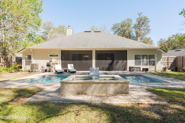 back of property with fence, a sunroom, a fenced in pool, an in ground hot tub, and a chimney