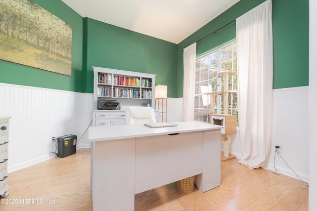 office featuring a wainscoted wall and light wood finished floors