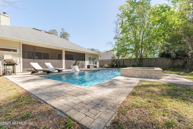 view of swimming pool with a patio area, a fenced backyard, a fenced in pool, and a sunroom