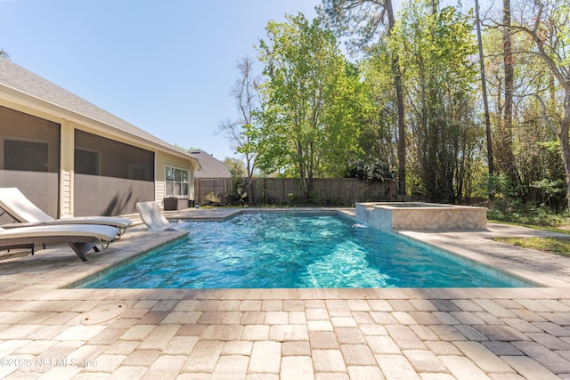 view of swimming pool featuring a patio, fence private yard, and a pool with connected hot tub