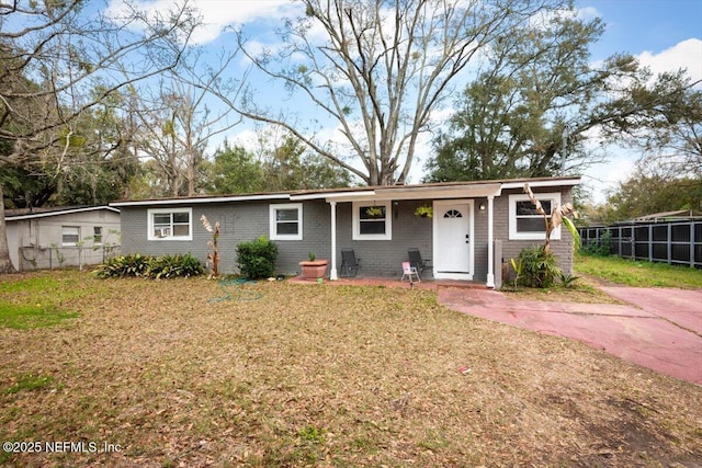 ranch-style house with brick siding, fence, and a front lawn