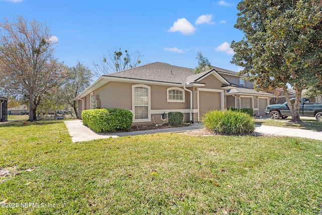 view of front of property featuring a garage, concrete driveway, a front lawn, and stucco siding