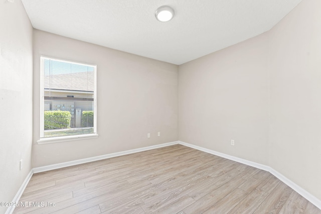 unfurnished room featuring wood finished floors and baseboards