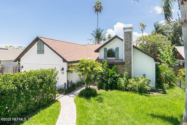 view of front of home featuring a garage, a chimney, fence, a front lawn, and stucco siding