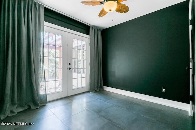 entryway with baseboards, dark tile patterned flooring, a ceiling fan, and french doors