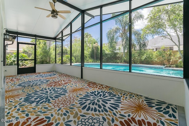 unfurnished sunroom featuring lofted ceiling and ceiling fan