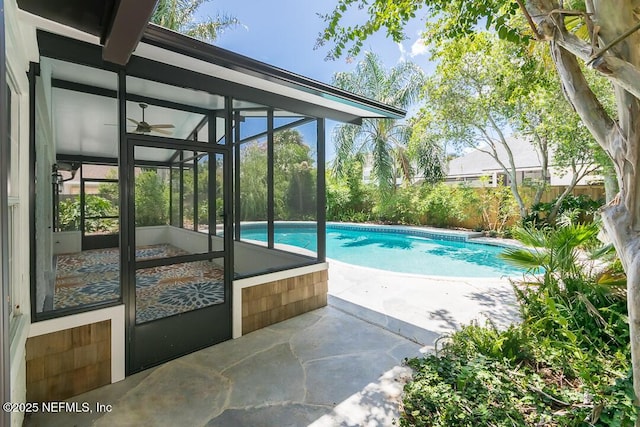 outdoor pool featuring a lanai and a patio