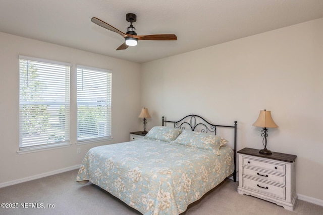 bedroom with light carpet, multiple windows, and baseboards