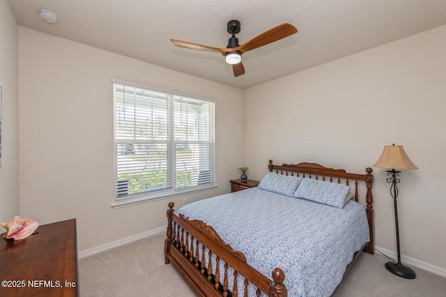 bedroom with baseboards, a ceiling fan, and light colored carpet