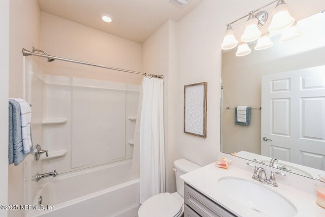 full bath featuring a chandelier, vanity, toilet, and shower / bath combo with shower curtain