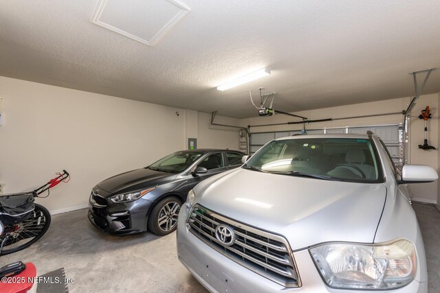 garage with baseboards and a garage door opener