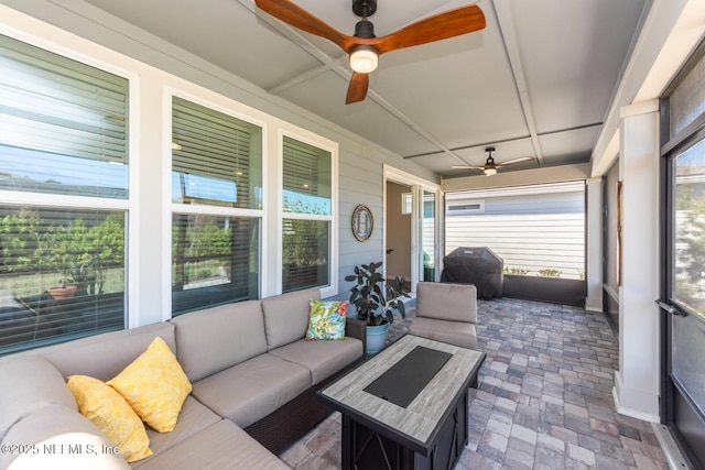 sunroom / solarium featuring ceiling fan and coffered ceiling