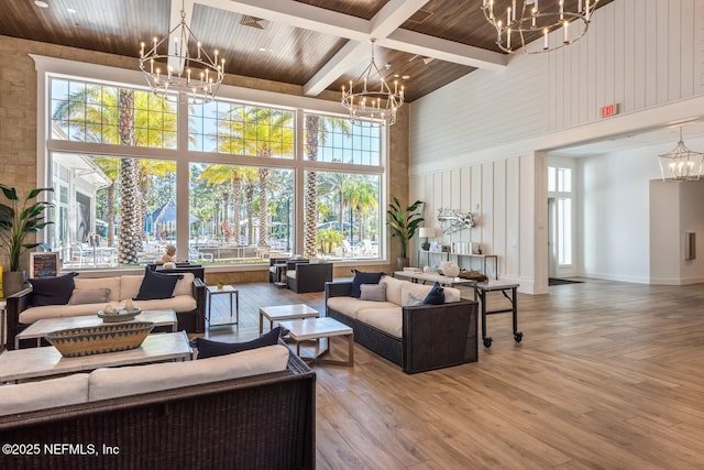 living area with an inviting chandelier and a high ceiling