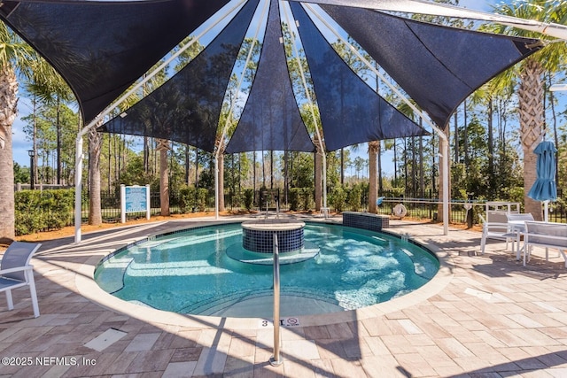 view of swimming pool featuring a patio area and fence